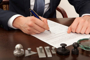 Northern VA traffic defense lawyer signing an agreement with a person charged of a wet reckless