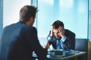 a businessman meeting a wrongful termination attorney discussing whether or not he is protected by freedom of speech in the workplace