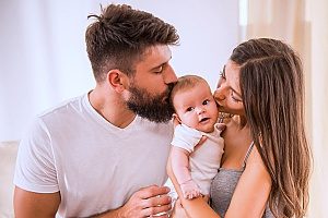 a newborn baby with his newly adopted parents who are both on parental leave for adoption thanks to the help of an employment law attorney