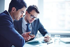 two employees working on a project for a company that has been recognized in Alexandria, VA since the company offers an incredible wage for their lowest earning employees