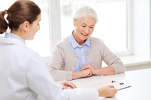 elderly woman with doctor discussing medicare