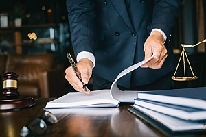 criminal defense attorney writing notes during a consultation with a potential client