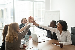 team of employees celebrating a victory