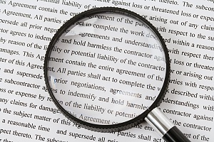 magnifying glass over a legal document to be ready carefully in a cda or nda