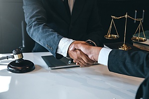 wage and hour dispute lawyer shaking hands with a client