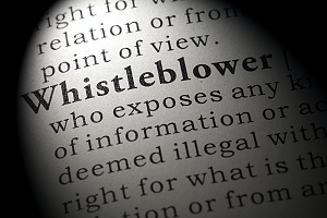 close up view of the definition of a whistleblower in a dictionary