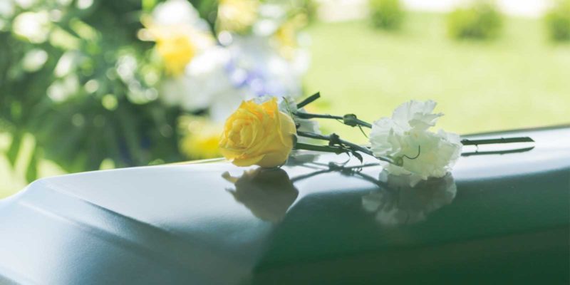 Flowers on casket at funeral