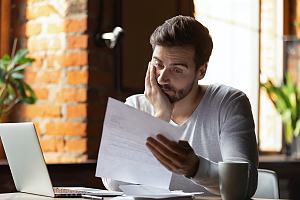 Worried person looking at finances 