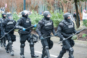 police officers put on extra equipment in case they have to use excessive force