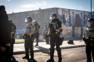 police officers are on guard during a protest against police using excessive force