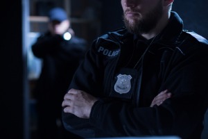 Close-up of police officers. When someone envisions unlawful detainment, they most often imagine a police officer