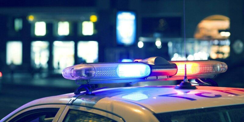 blue light flasher atop of a police car