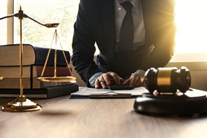 male lawyer working with calculator and wooden gavel