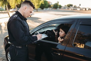 male police officers check vehicle on the road