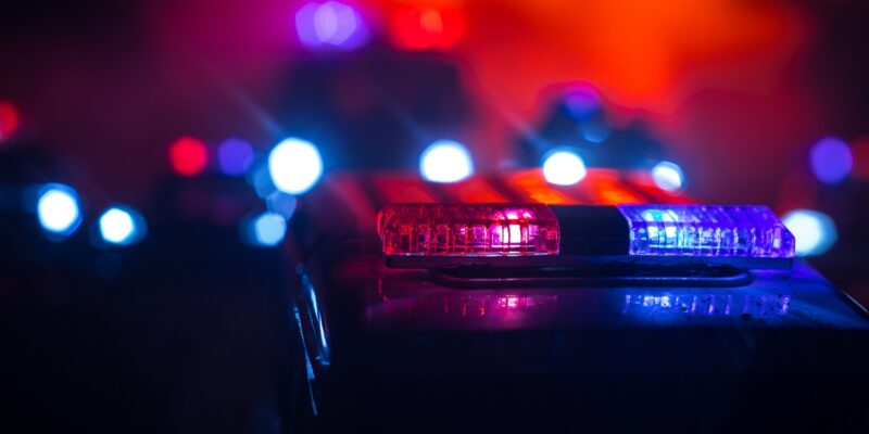 police car chasing a car at night with fog background