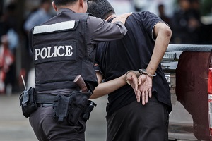 police officer arresting a protesting man