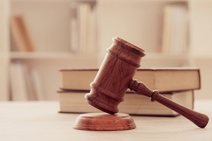 judges gavel on wooden table with law books