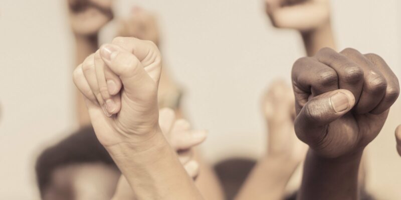 people raised fist air fighting for their rights