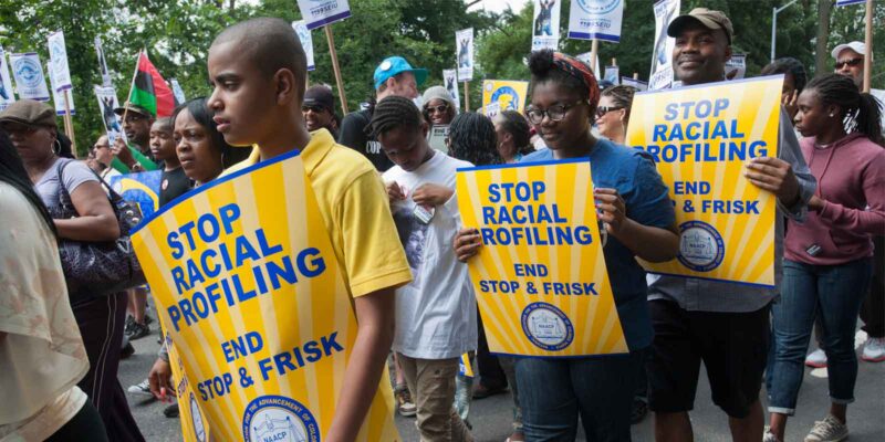 a group of protestors raising awareness about police racial profiling