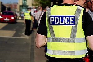 police officer with a yellow vest on scene