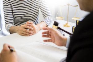 A woman is consulting a legal professional at The Brown Firm