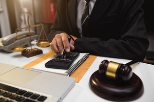 An attorney calculating his bill amount over his desk