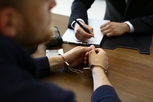 A man consulting an attorney after being prosecuted with malice