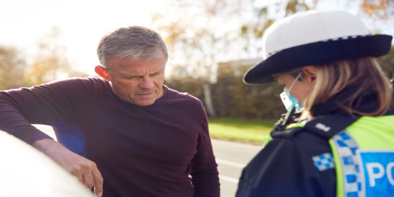 A middle-aged man stopped by a female traffic police officer