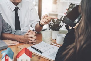 Two employees arguing with their employer inside the office